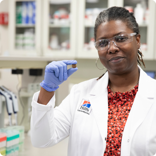 Hill's Pet Nutrition researcher holds Hill's Pet food in her hand.